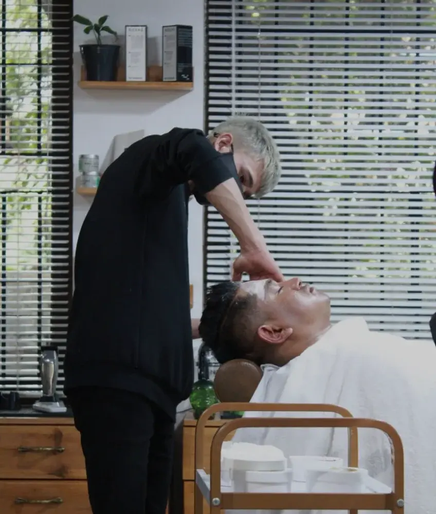 Barber doing a facial for a customer